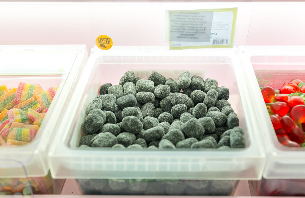 A tub of sugared black licorice pieces